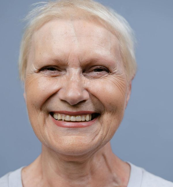 A confident woman smiling, showcasing a natural sense of well-being.