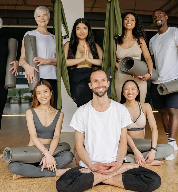 Diverse group of people feeling relaxed and happy during a wellness class.