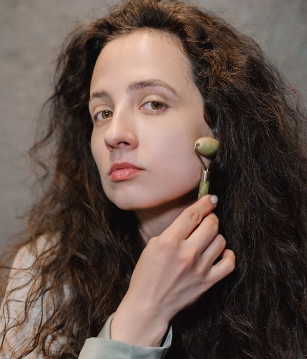 Woman feeling refreshed and glowing after a face yoga session.